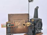 an old fashioned sewing machine and a box with a picture on it