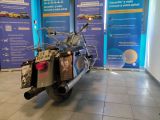 a motorcycle that is parked in front of a blue wall