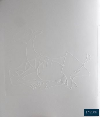 someone is drawing a deer on a piece of paper on a table