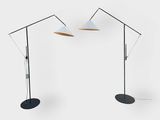 a pair of floor lamps with a white shade and a black base