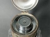 a silver container with a silver lid on a table