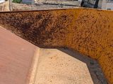 a rusted metal structure on the roof of a building