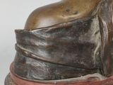 bronze statue of a woman with a hat on her head