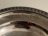 a silver plate with a number on it sitting on a table