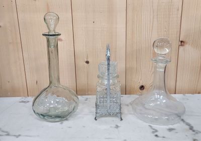 three glass vases sitting on a marble counter top