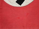 a red and white flag with a black cross on it