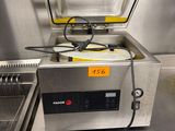 a machine that is sitting on a table in a kitchen
