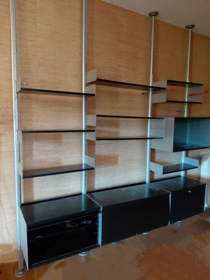 a black entertainment center with a flat screen tv in the corner