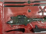 a toy army helicopter in a plastic package