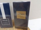 two boxes of perfume sitting on top of a table next to each other
