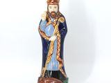 figurine of a man in a blue robe with a dog on a leash