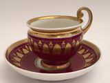 a cup and saucer on a saucer on a white table