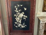 a tall wooden screen with a floral design on it