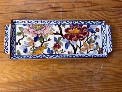 un plateau décoratif orné de fleurs, posé sur une table en bois