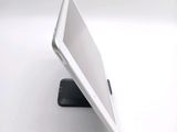 a white tablet computer sitting on top of a black stand
