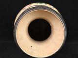 a close up of a vase on a black surface