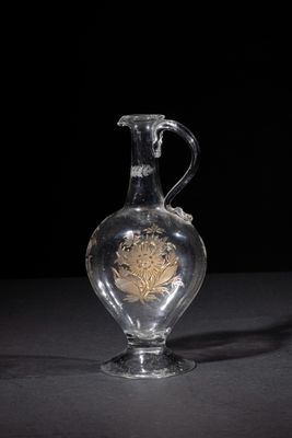 a clear glass vase with a gold design on it