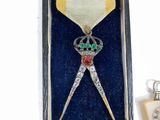a medal in a box with a keychain on it