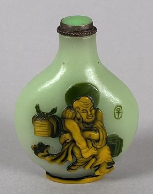 a green glass bottle with a picture of a man holding a pot