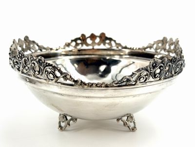 a silver bowl that is sitting on a stand