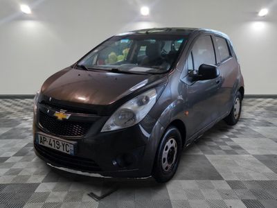 a picture of a chevrolet spark car in a showroom
