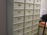 a stack of filing cabinets in the corner of a room