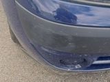 a close up of a car ' s headlight and front bumper