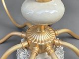 a white and gold candle holder on a table
