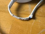 a white cord that is connected to a white device on a table