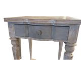 a small table with a drawer on top of it