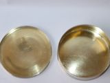 two brass plates with a white background and a white background