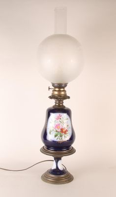 a lamp that is sitting on a table next to a white wall