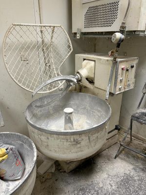 a large metal bowl sitting in the corner of a room