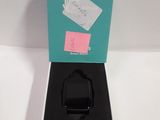 a box with a watch inside of it on a white surface