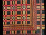 a close up of a red, yellow and black checkered cloth