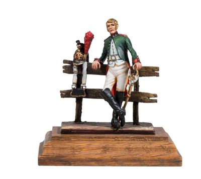 a figurine of a man sitting on a bench with a dog