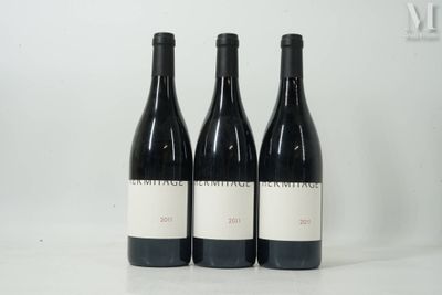three bottles of wine are sitting on a table