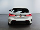 the rear end of a white bmw car in a white room