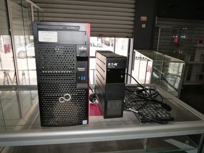 two computers that are on display in a glass case