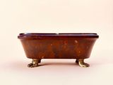 a brown bath tub with a brown lid on a white surface