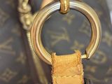 a close up of a brown bag with a ring on it