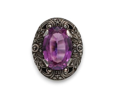 a close up of a purple stone in a silver setting