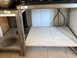 an image of a kitchen with a microwave on a stand