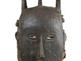 an image of a wooden mask with horns on a white background
