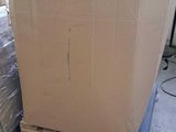a large cardboard box sitting on a pallet in a warehouse
