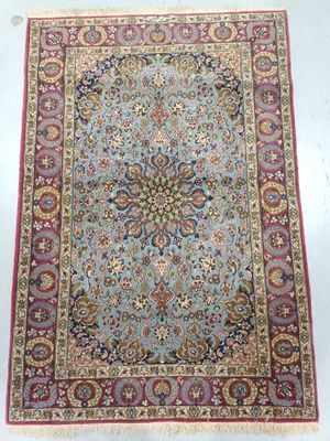 a blue and red rug with a medallion design on it