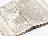 an old book with a map on top of it