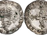 a silver coin with a cross on the front and a cross on the back
