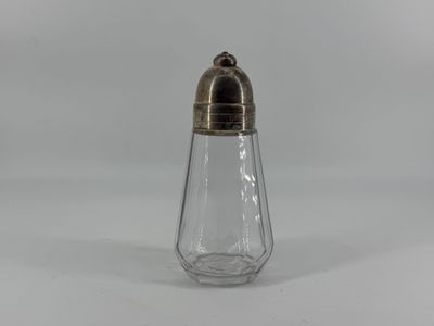 a silver and glass salt shaker with a gold top