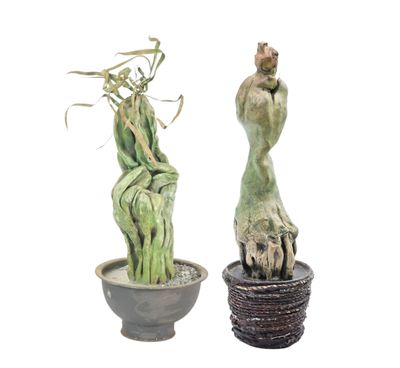 two statues of a man and a plant in a pot